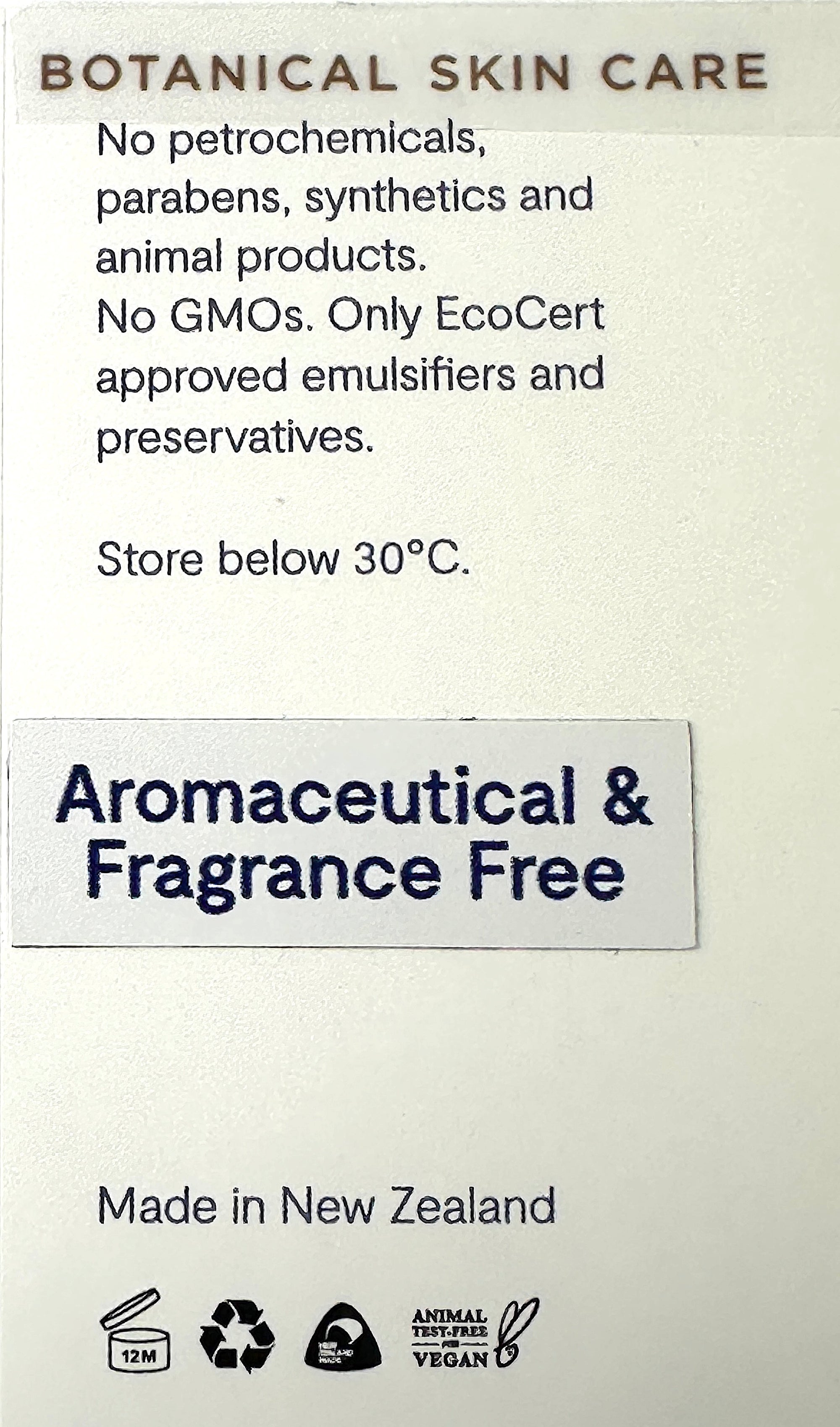A close-up of a botanical skin care product label with text reading 'Aromaceutical &amp; Fragrance Free' on a light beige background, plus claims about no petrochemicals, parabens, synthetics, and GMOs, plus New Zealand origin and certification icons.