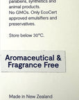 A close-up of a botanical skin care product label with text reading 'Aromaceutical & Fragrance Free' on a light beige background, plus claims about no petrochemicals, parabens, synthetics, and GMOs, plus New Zealand origin and certification icons.
